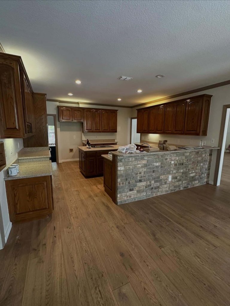 kitchen before image with dark cabinets and brick half wall in Fair Oaks Ranch TX kitchen remodel by Shaw Construction Services