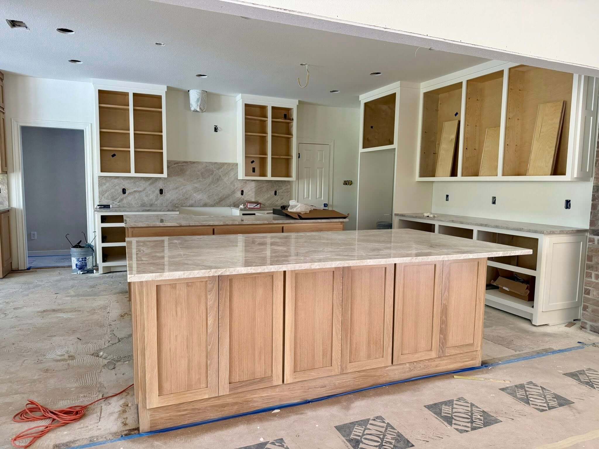 mid project painted oak cabinets and Taj Mahal countertops in Fair Oaks Ranch TX kitchen remodel by Shaw Construction Services