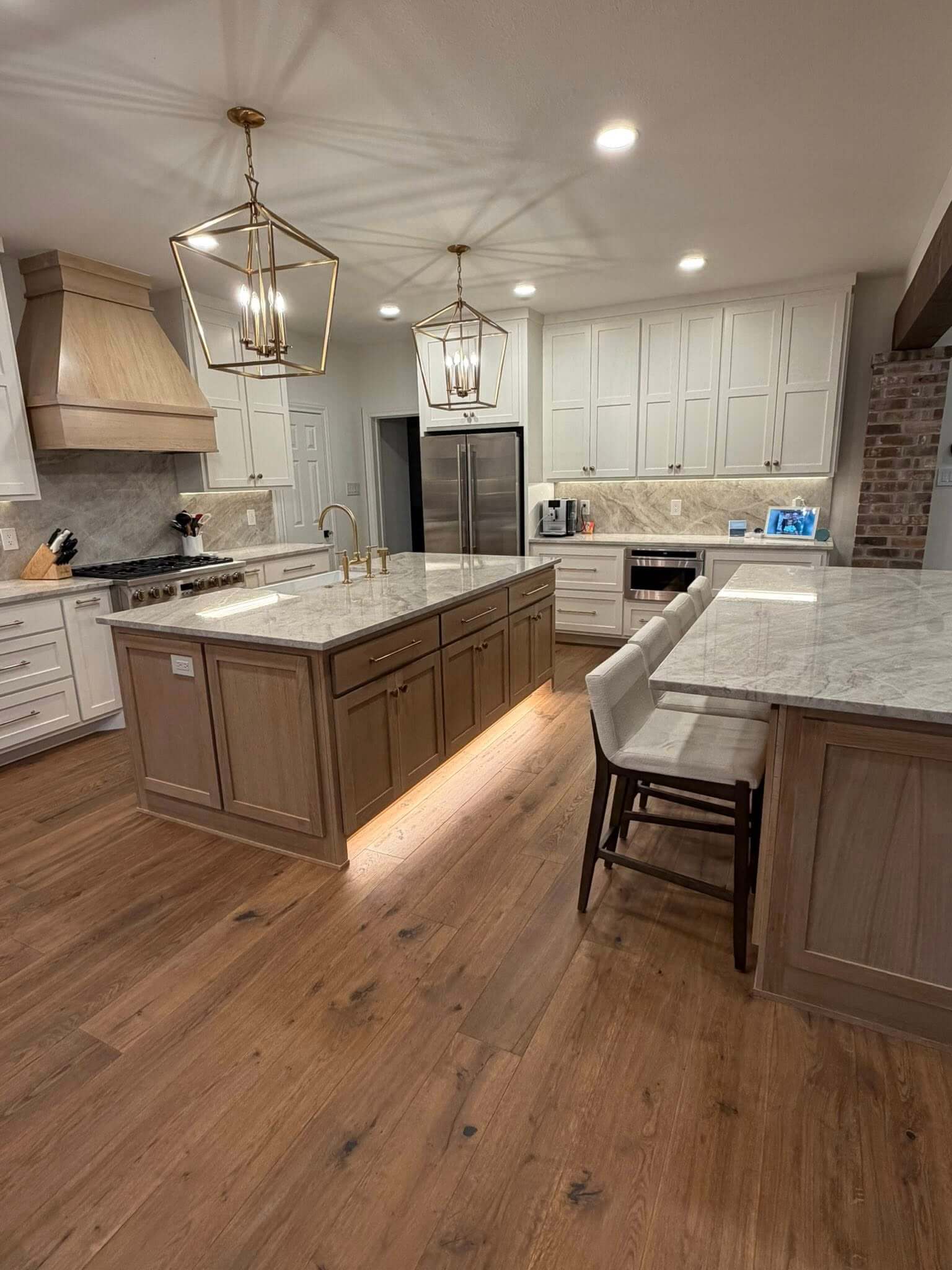 New flooring, cabinets, countertops, and lighting installed during a kitchen remodel in Fair Oaks Ranch TX by Shaw Construction Services